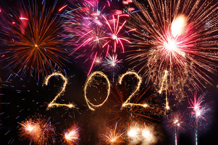 2021 Happy New Year written with Sparkle firework on black background,の写真素材