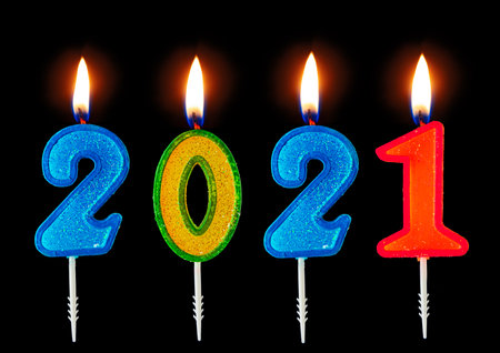 2021 Happy new year burning party candles isolated on black.の写真素材