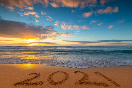 Happy New Year 2021 concept, lettering on the beach. Written text on the sea beach at sunrise.の写真素材