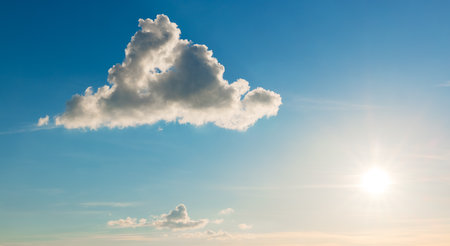 Blue sunset sky and white fluffy cloud as nature backgroundの写真素材