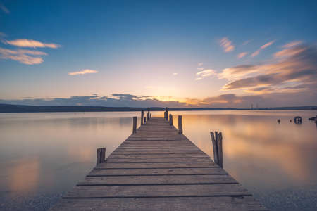 Old wooden dock at the lake, sunset shotの写真素材