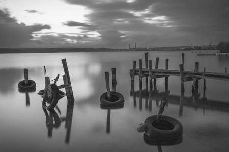 Small dock and fishing boat at fishing village, black and white long exposureの写真素材