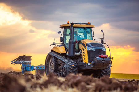 Tractor plowing the fields , agricultural landscapeの写真素材