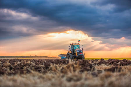 Tractor plowing the fields , agricultural landscapeの写真素材