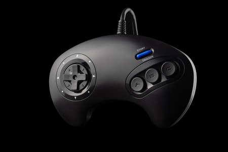 Retro joystick from 8-bit consoles. Game controller isolated on black backgroundの写真素材