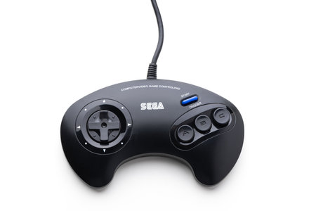Varna, Bulgaria, 30 Mart 2021:- A retro Sega Mega Drive 16-bit gaming console's controller isolated on a white background Retro joystick from 8-bit consoles. Game controller isolated on black backgroundのeditorial素材
