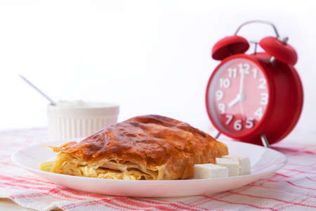 Baked cheese pie with milk. Bulgarian butter banitsa for breakfastの写真素材