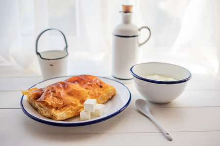 Baked cheese pie with milk. Bulgarian butter banitsa for breakfastの写真素材