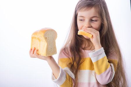 Little girl hold slice of homemade healthy breadの写真素材