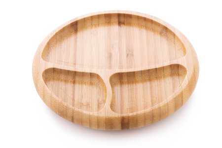 Wooden bowl. Bamboo plate isolated on white backgroundの写真素材