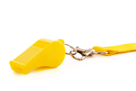 Yellow sport whistle isolated on white backgroundの写真素材