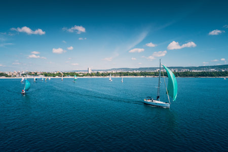 Regatta sailing ship yachts with white sails at opened sea. Aerial view of sailboat in windy condition.のeditorial素材