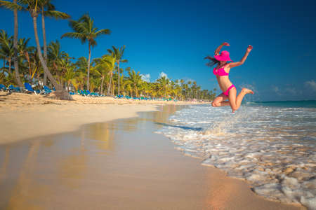Carefree young woman relaxing on tropical beachの写真素材