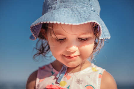 Little girl playing on the beach with toysの写真素材