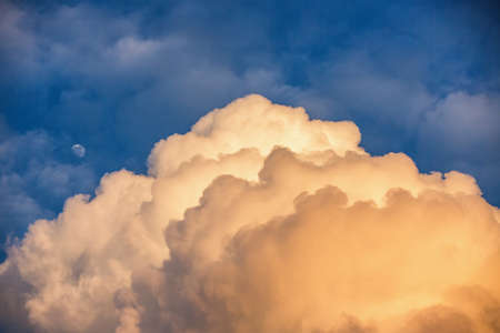 Sunset sky with moon and cloudsの写真素材
