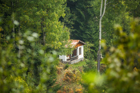Mountain autumn landscape with colorful forest and traditional housesの写真素材