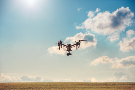 Flying drone and green wheat field