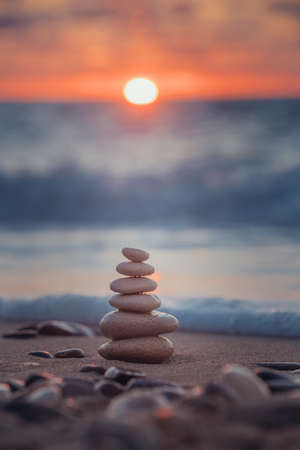 Stones balance on beach, sunrise shotの写真素材