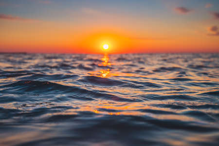 Sea wave close up, low angle view, sunrsie shot.の写真素材
