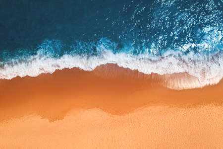 Aerial top view from drone of sandy beach with turquoise sea waves with copy space for text.の写真素材