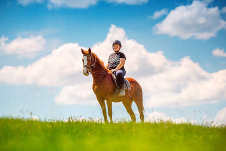 Young Boy riding a horse in the fieldの写真素材