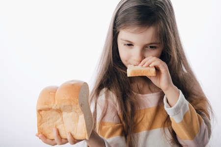 Little girl hold slice of homemade healthy breadの写真素材