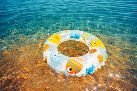 Children buoy in sea water. Swimming ring on the beach.の写真素材