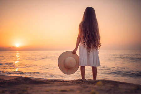 Happy Carefree Girl on the Beach at Sea Sunriseの写真素材