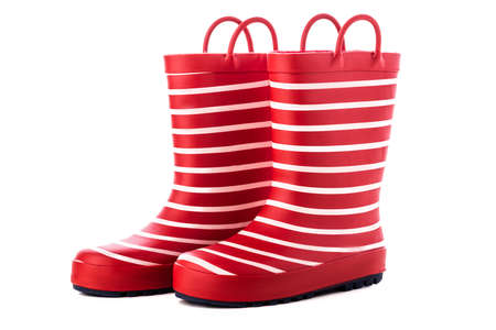 Red striped kids rubber boots for rain isolated on white background.の写真素材
