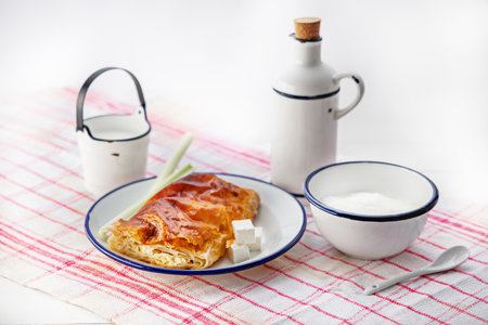 Baked cheese pie with milk. Bulgarian butter banitsa for breakfastの写真素材