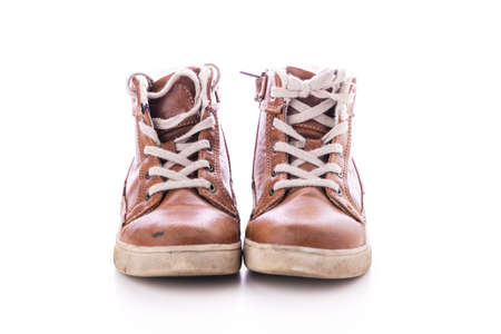 Old & dirty used shoes isolated on white backgroundの写真素材