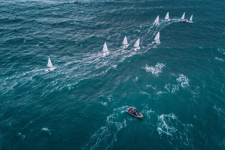 VARNA, BULGARIA , October 05, 2021: Sailing regatta in the open sea. Sailing boat compete for the regatta Varna Senior Sailing European Championshipsのeditorial素材