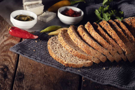 Top view of bread with cheese and chili pepper on the wooden tableの写真素材