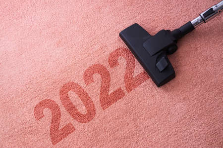 2022 New year home cleaning with vacuum cleaner and copy space for a textの写真素材