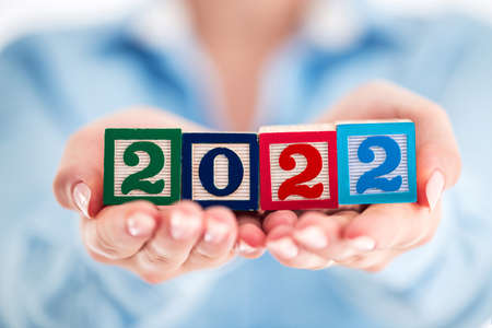 2022 Business concept. Woman holding wooden cubes.の写真素材