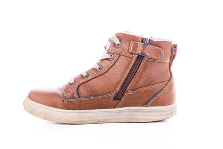 Old & dirty used shoe isolated on white backgroundの写真素材