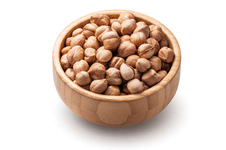 Hazelnuts in wooden bowl on white background. Raw nuts isolated.の写真素材
