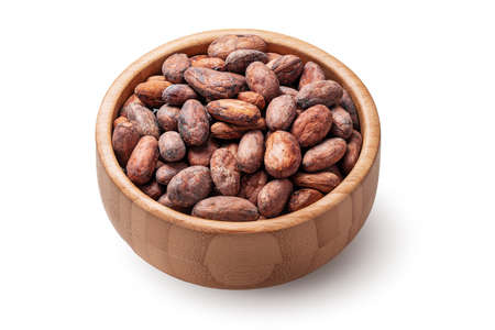 Cacao beans in wooden bowl isolated on white background.の写真素材