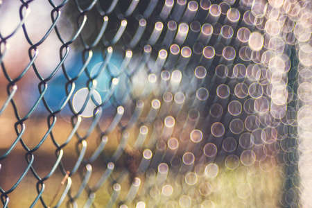 Old rusty metal wire mesh outdoor defocus background, blurred texture, soft focus vintage lensの写真素材