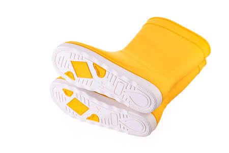 Yellow rubber boots isolated on white background. Kids shoes.の写真素材