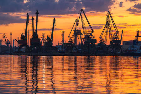 Colorful sunset over sea port and industrial cranes, Varna, Bulgariaの写真素材