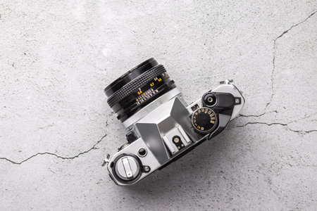 Old vintage camera, lens and film camera picture roll close up on stone backgroundの写真素材