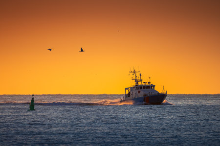 Boat and sunrise, beautiful cloudscapeの写真素材