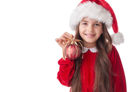 Smiling woman with Christmas tree shining ball, girl posing in red dress of Santa Claus on white backgroundの写真素材