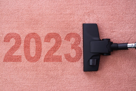 2023 New year home cleaning with vacuum cleaner and copy space for a textの写真素材