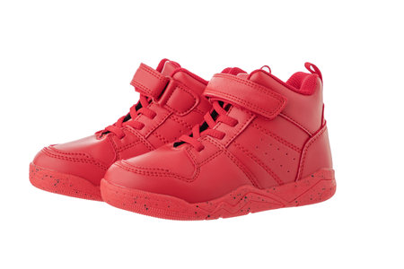 Red kids shoes. Sport sneakers isolated on white backgroundの写真素材