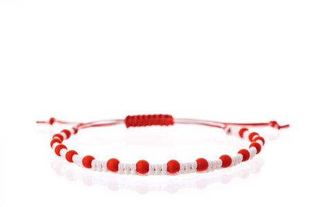 Martisor talisman, martenitsa, martenitza for 1 March Baba Marta isolated on white background. Traditional accessory for holiday of early spring in Bulgaria, Romania, Moldova. Red and White yarn strings.の写真素材