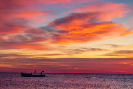 Boat and sunrise, beautiful cloudscapeの写真素材
