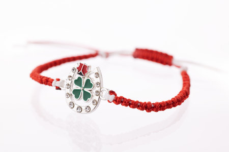 Martisor talisman, martenitsa, martenitza for 1 March Baba Marta isolated on white background. Traditional accessory for holiday of early spring in Bulgaria, Romania, Moldova. Red and White yarn strings.の写真素材