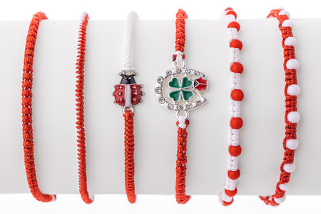 Martisor talisman, martenitsa, martenitza for 1 March Baba Marta isolated on white background. Traditional accessory for holiday of early spring in Bulgaria, Romania, Moldova. Red and White yarn strings.の写真素材